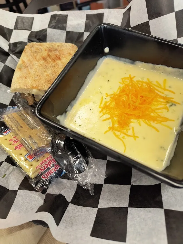 Broccoli Cheddar Soup with a Half of a Steak and Cheese Sandwich